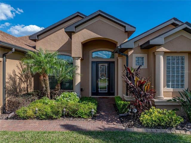 entrance to property with stucco siding