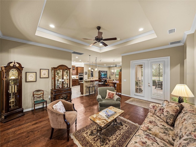 living room featuring a tray ceiling, french doors, dark wood finished floors, a ceiling fan, and baseboards