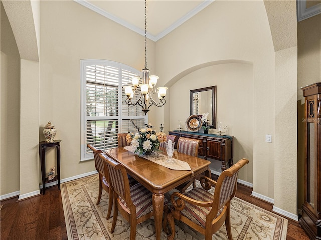 dining space featuring dark wood-style floors, baseboards, a chandelier, and ornamental molding