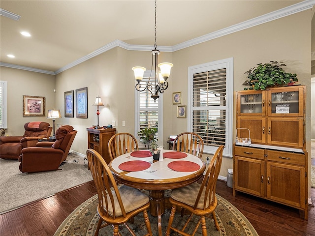 dining space with a notable chandelier, visible vents, dark wood-type flooring, and ornamental molding