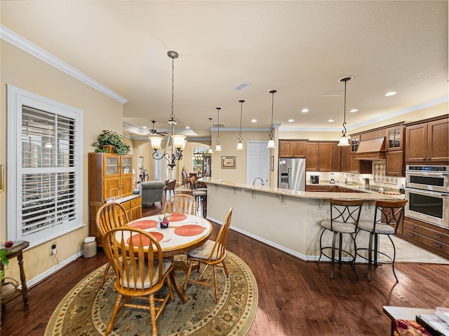 dining room featuring baseboards, visible vents, dark wood-style floors, crown molding, and recessed lighting