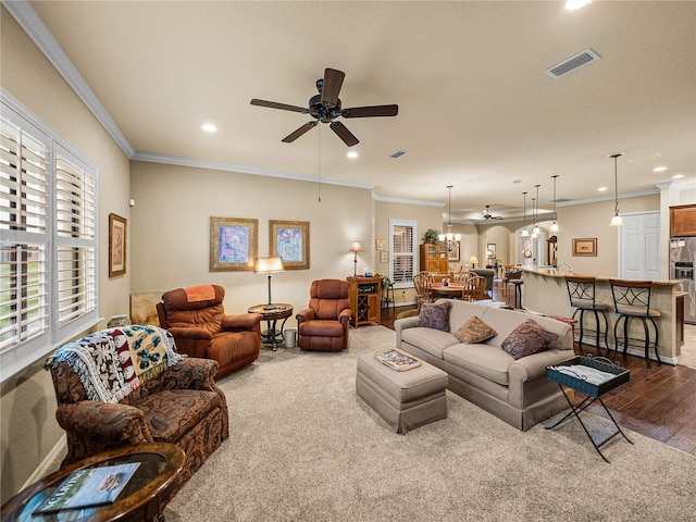 living room featuring ornamental molding, recessed lighting, visible vents, and a ceiling fan