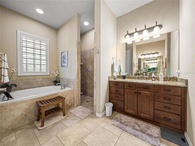 bathroom featuring a walk in shower, tile patterned flooring, vanity, and a bath