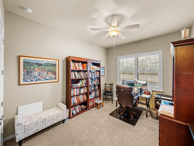 office featuring carpet flooring, ceiling fan, and a textured ceiling