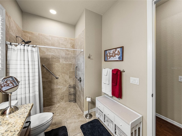 full bathroom with toilet, baseboards, tiled shower, and tile patterned floors