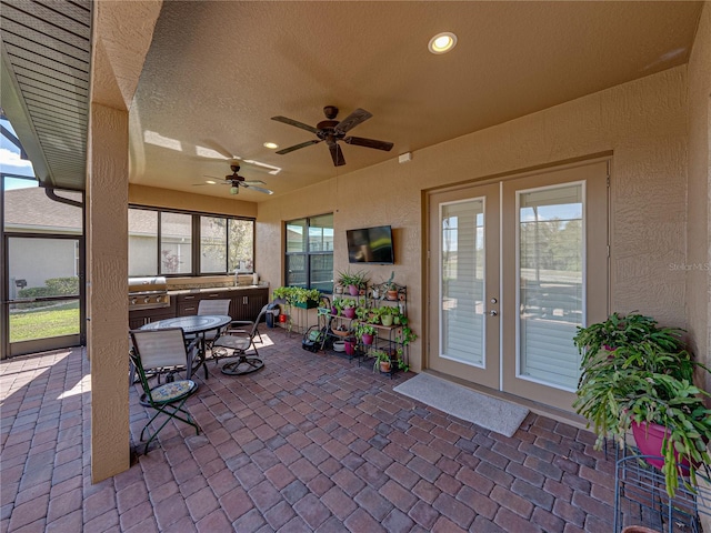 view of patio with french doors, ceiling fan, outdoor dining area, and area for grilling