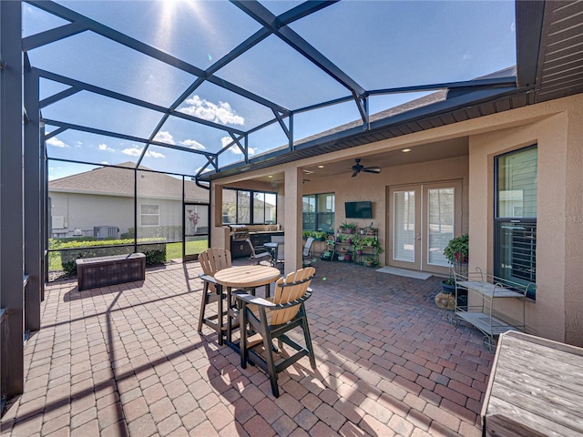 view of patio featuring french doors, ceiling fan, and a lanai