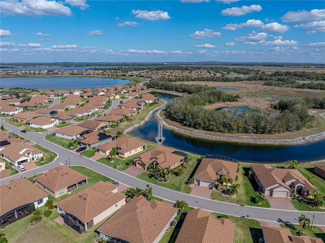 drone / aerial view featuring a water view and a residential view