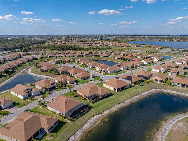 drone / aerial view with a residential view and a water view