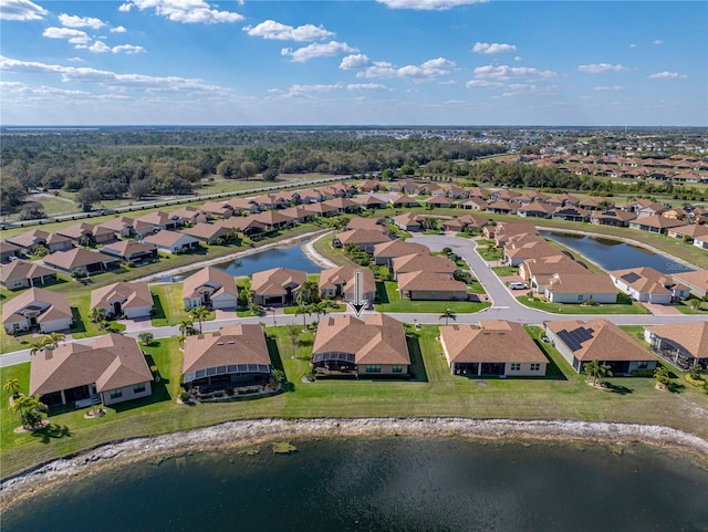 drone / aerial view featuring a water view and a residential view