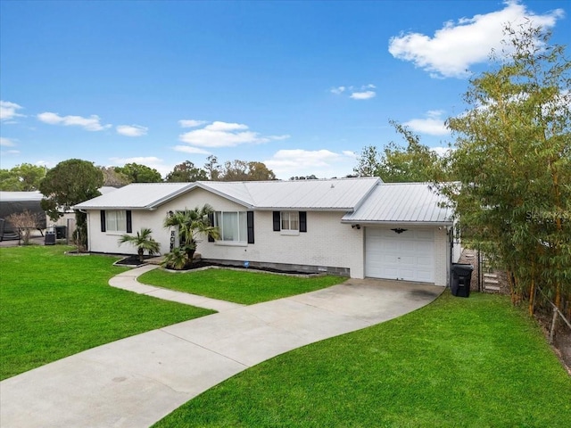 ranch-style home with metal roof, a garage, brick siding, driveway, and a front lawn