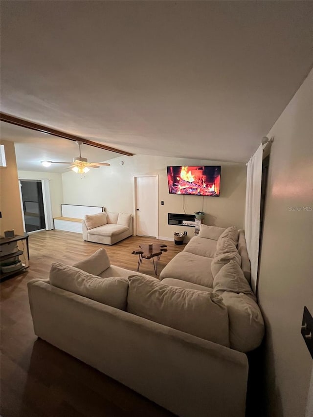 living area with wood finished floors and a ceiling fan