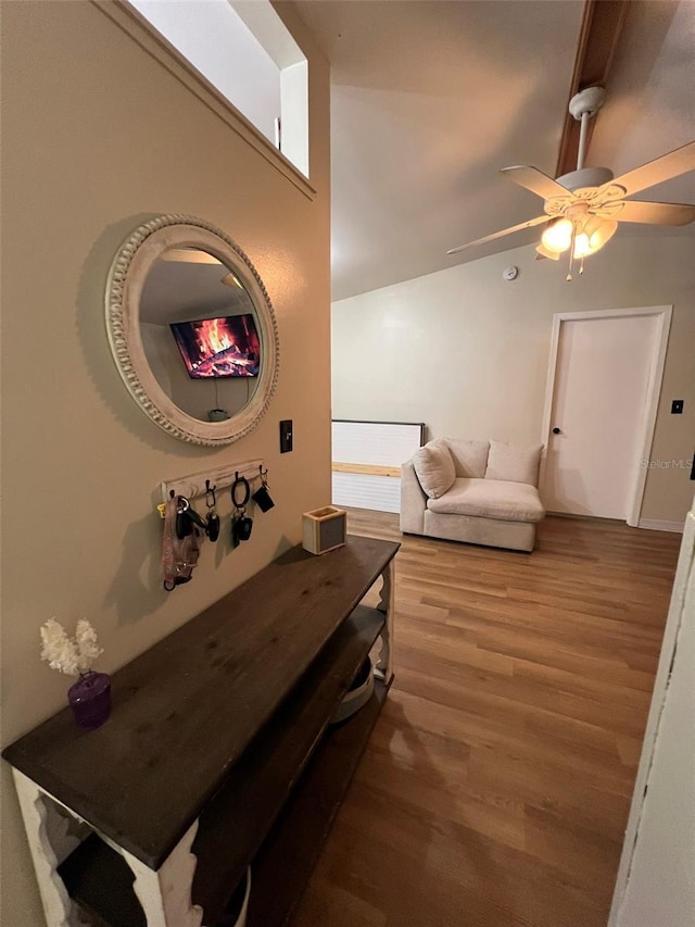 hallway with lofted ceiling and wood finished floors