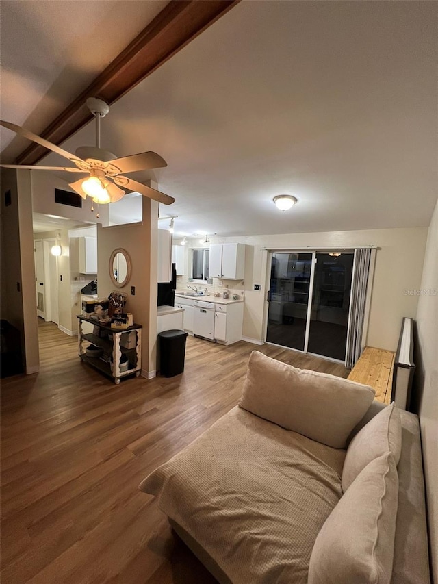 living room with ceiling fan, lofted ceiling with beams, baseboards, and wood finished floors