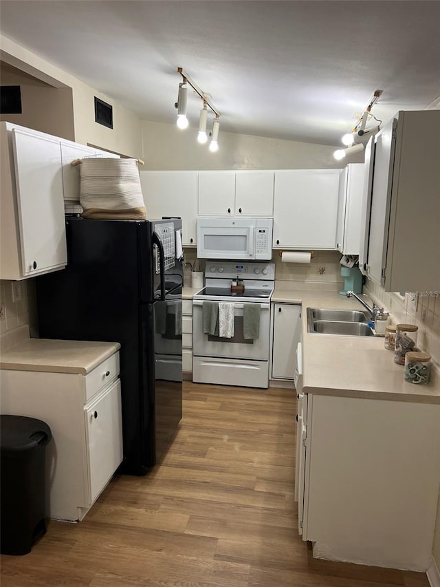 kitchen featuring white appliances, a sink, white cabinetry, light countertops, and backsplash