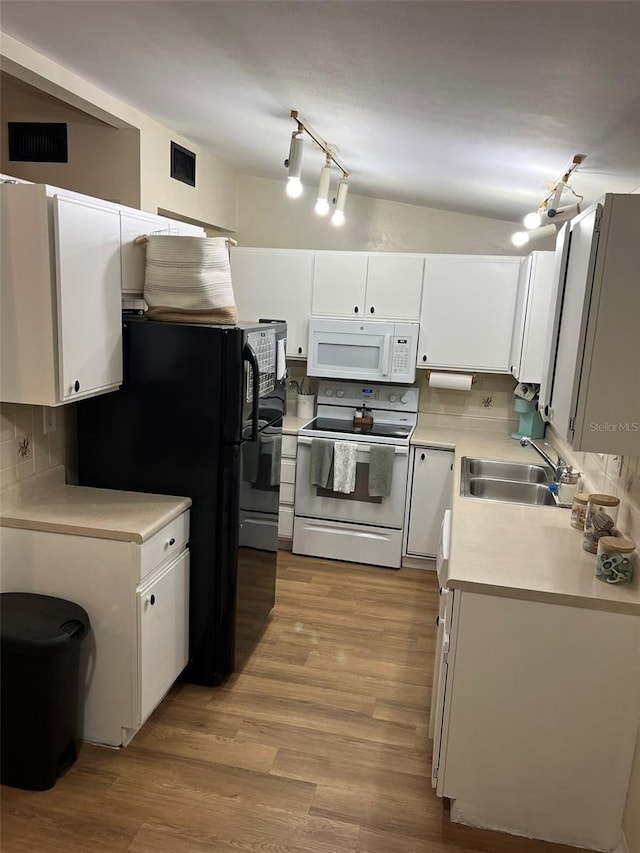 kitchen with light countertops, decorative backsplash, white cabinetry, a sink, and white appliances