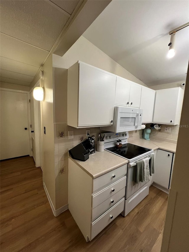 kitchen with white appliances, light countertops, light wood-style floors, white cabinetry, and backsplash