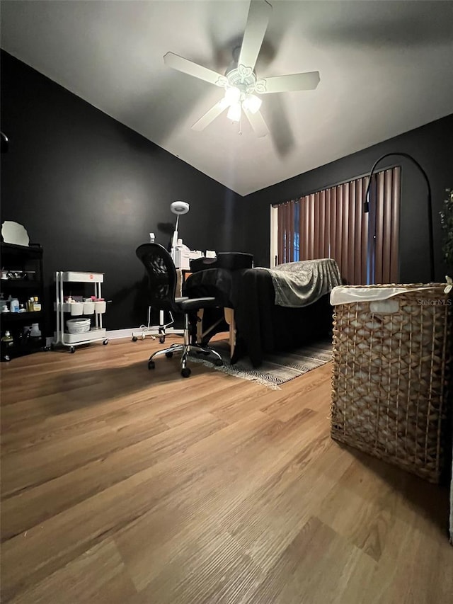 bedroom with vaulted ceiling, wood finished floors, and a ceiling fan