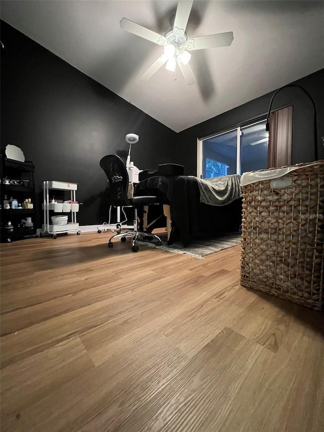 home office with lofted ceiling, a ceiling fan, and wood finished floors