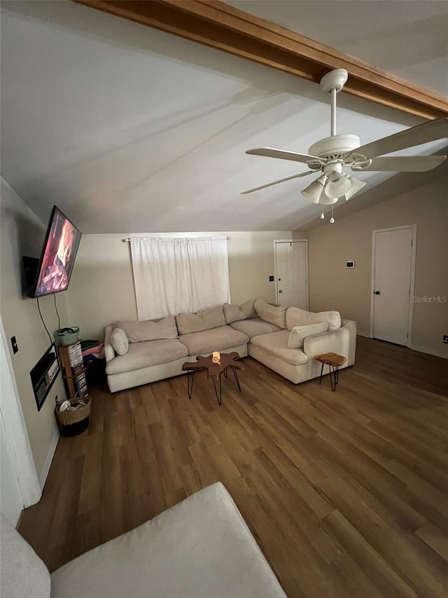 unfurnished living room featuring lofted ceiling with beams, ceiling fan, baseboards, and wood finished floors