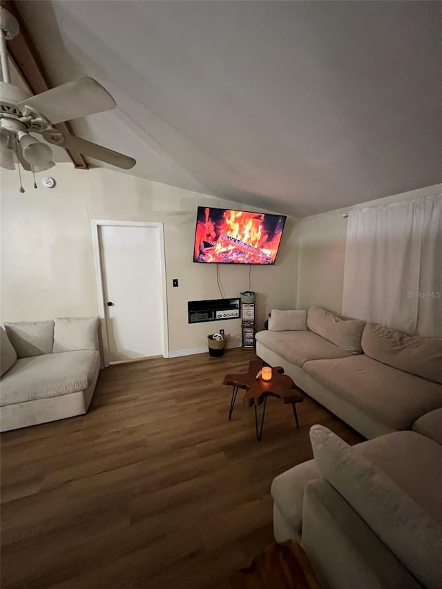 living area featuring a ceiling fan, vaulted ceiling, and wood finished floors