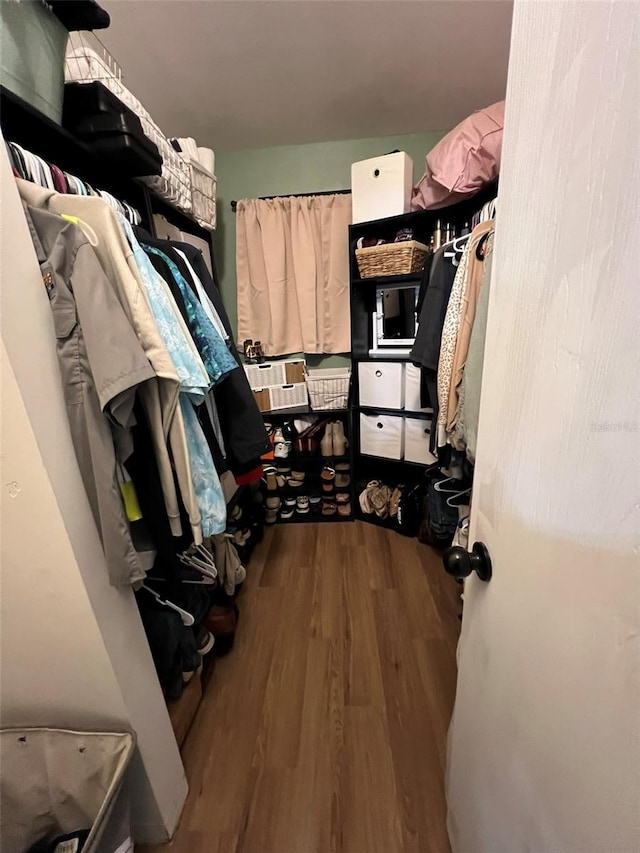 spacious closet with wood finished floors