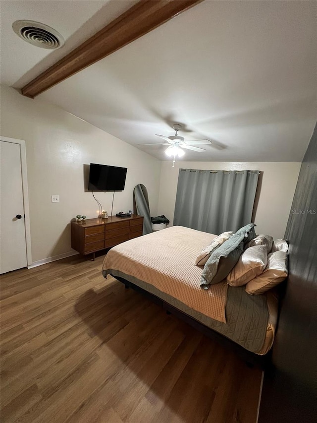 bedroom featuring vaulted ceiling with beams, visible vents, ceiling fan, wood finished floors, and baseboards