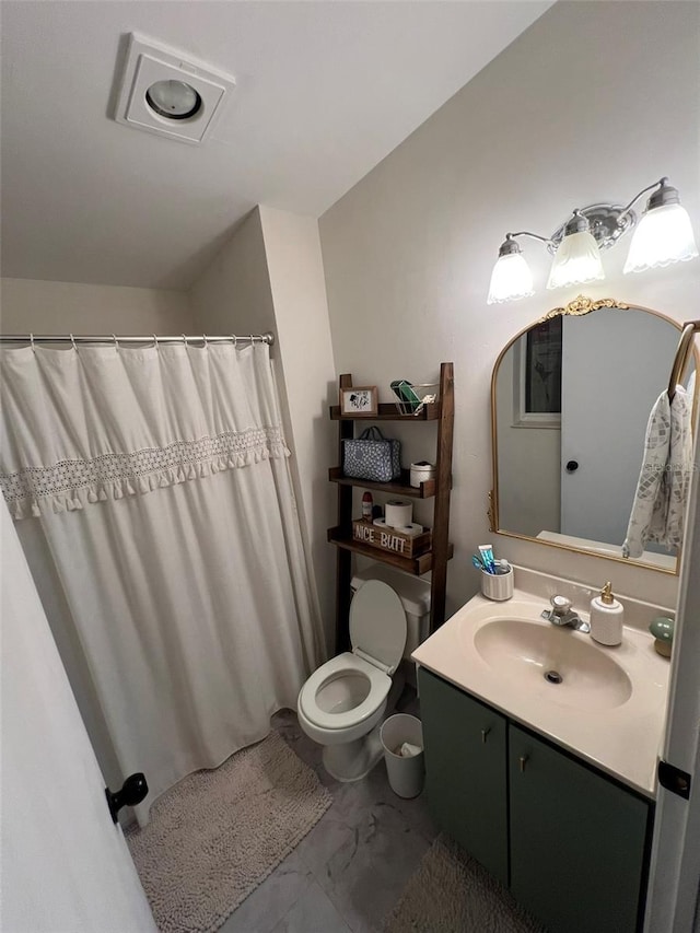 bathroom with marble finish floor, vanity, and toilet