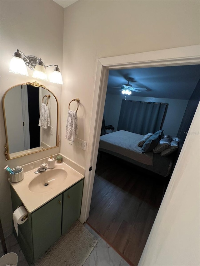 bathroom featuring marble finish floor and vanity