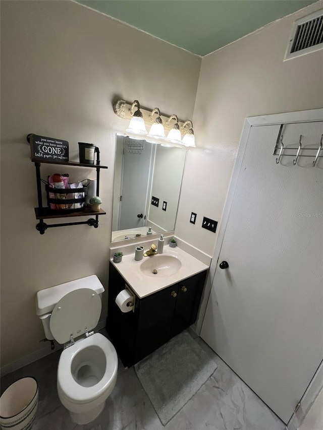 bathroom featuring marble finish floor, visible vents, vanity, and toilet