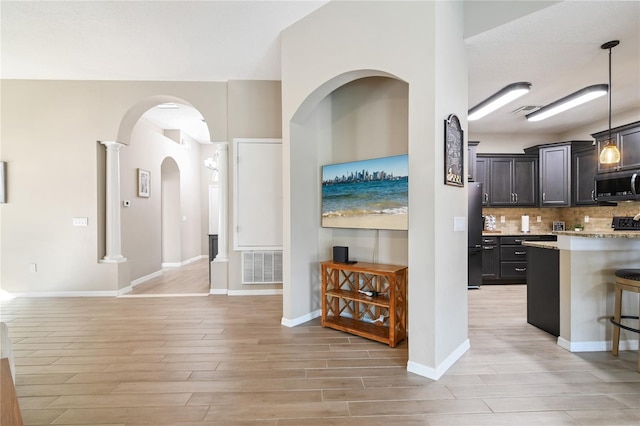 interior space featuring light wood-style floors, baseboards, and visible vents