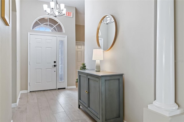 entrance foyer with baseboards and a notable chandelier