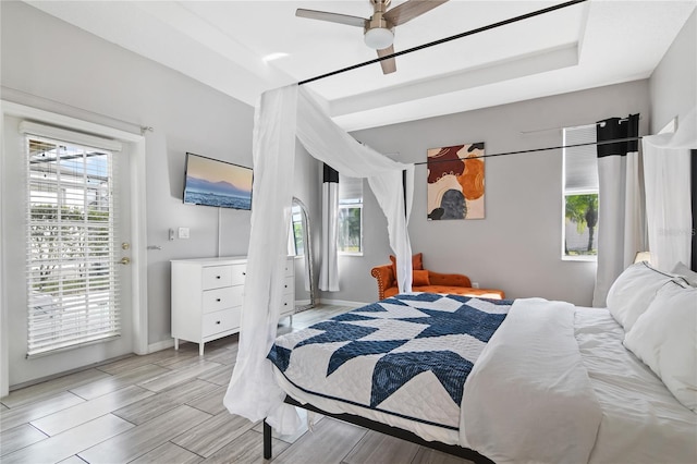 bedroom with access to exterior, wood tiled floor, baseboards, and ceiling fan