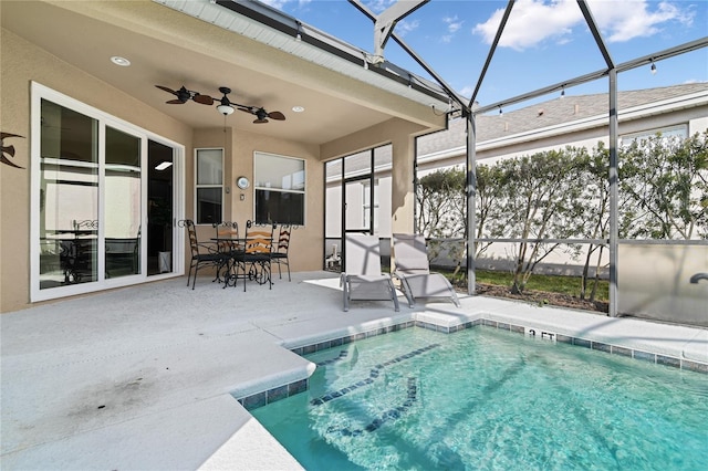 pool with a ceiling fan, a lanai, a patio, and outdoor dining area