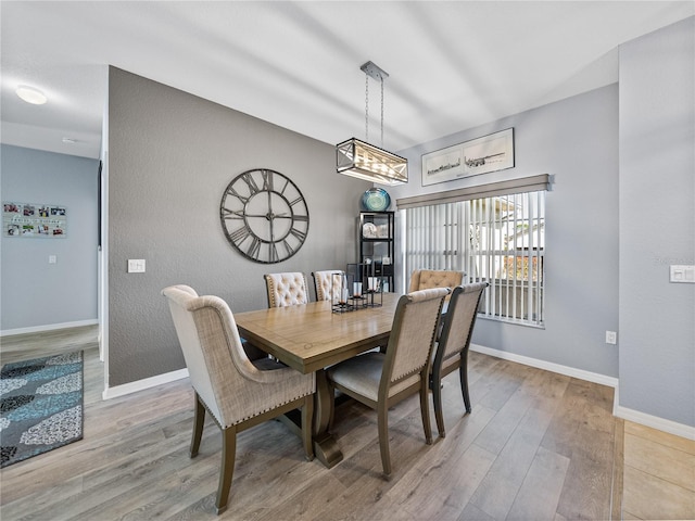 dining room featuring wood finished floors and baseboards