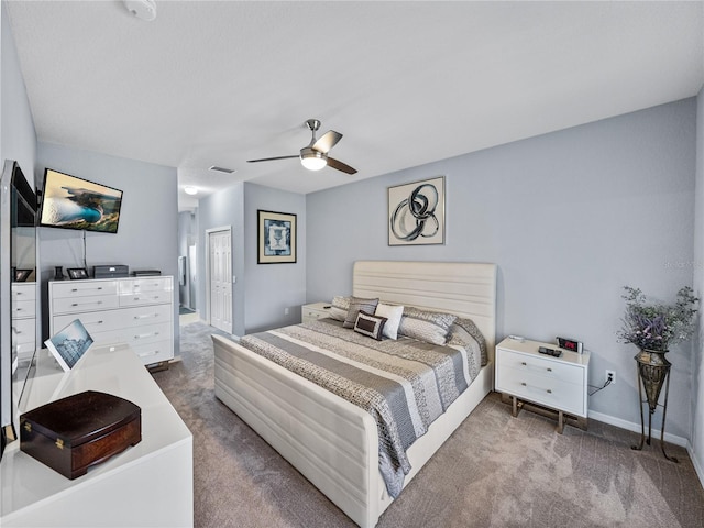 bedroom featuring a ceiling fan, a closet, carpet flooring, and baseboards