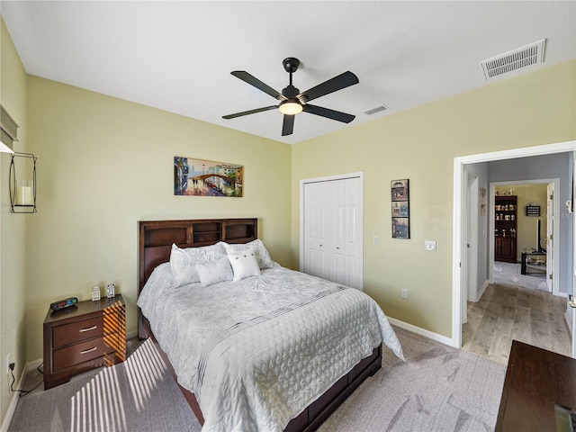 bedroom featuring baseboards, visible vents, ceiling fan, and a closet