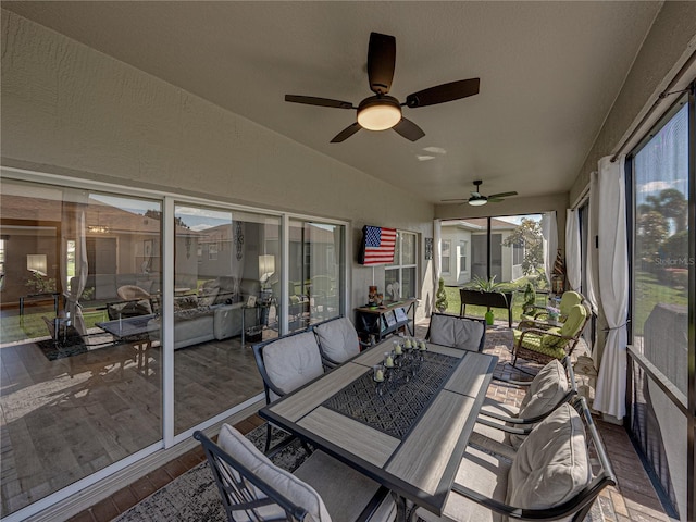 sunroom / solarium featuring vaulted ceiling