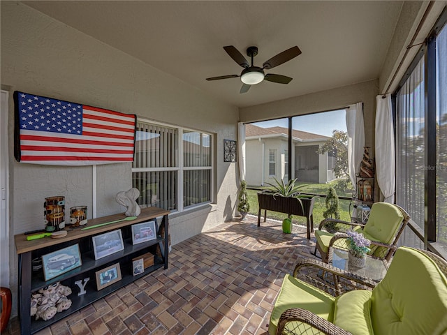 sunroom / solarium featuring ceiling fan