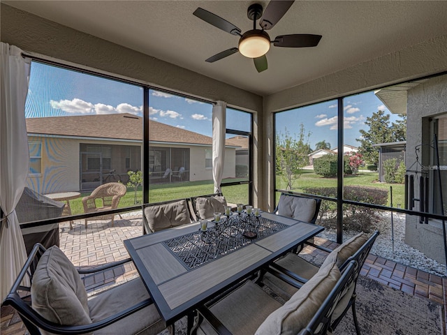 sunroom / solarium with a ceiling fan