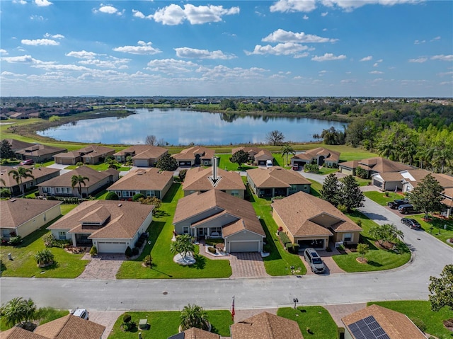 drone / aerial view with a residential view and a water view