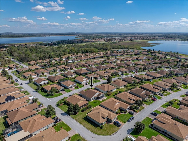 birds eye view of property with a water view and a residential view