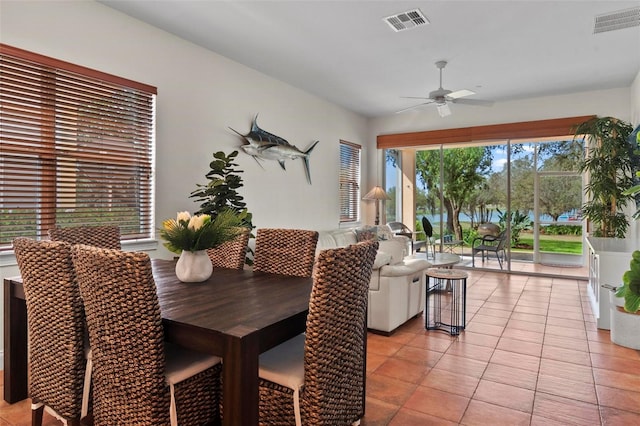 dining room featuring light tile patterned floors, visible vents, and a ceiling fan