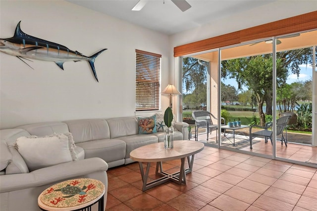 living area with tile patterned flooring and ceiling fan