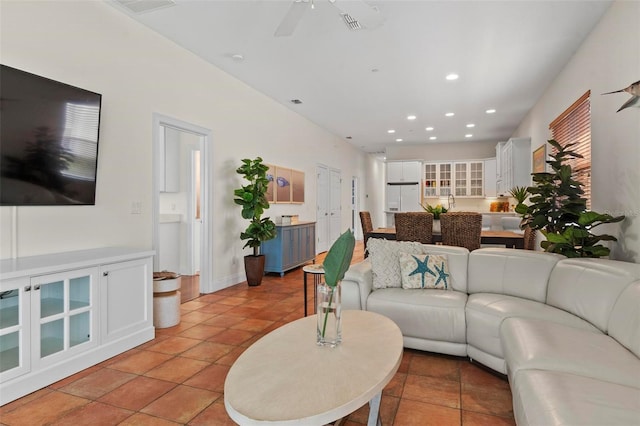 living room featuring recessed lighting, ceiling fan, baseboards, and light tile patterned floors