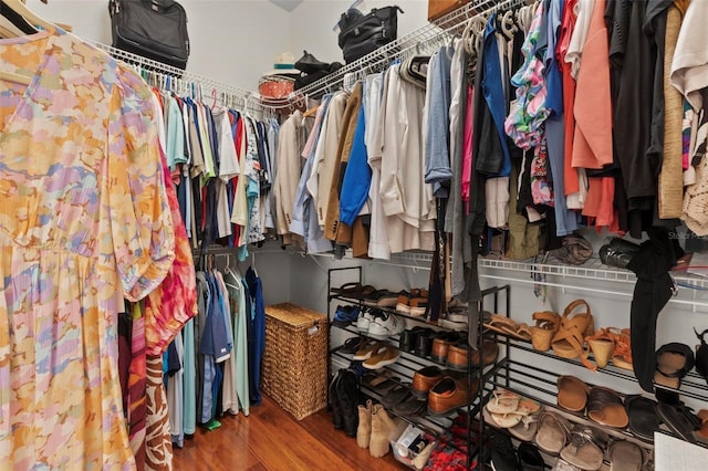 walk in closet featuring wood finished floors