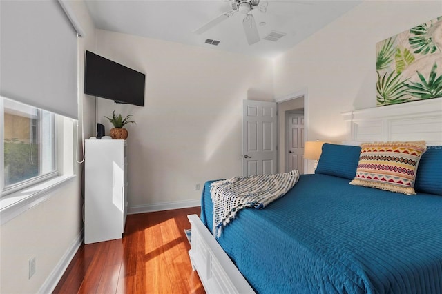 bedroom featuring dark wood-style flooring, visible vents, and baseboards