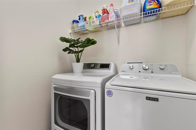 clothes washing area featuring washing machine and dryer and laundry area