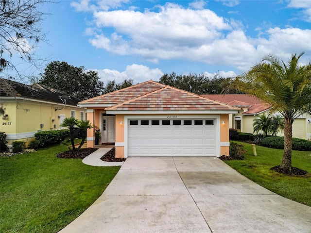 ranch-style house featuring a front yard, driveway, an attached garage, and stucco siding