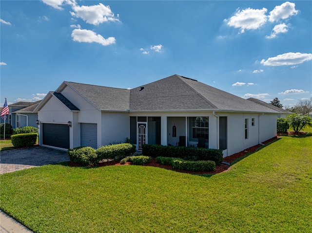 ranch-style house with a garage, a front yard, decorative driveway, and stucco siding